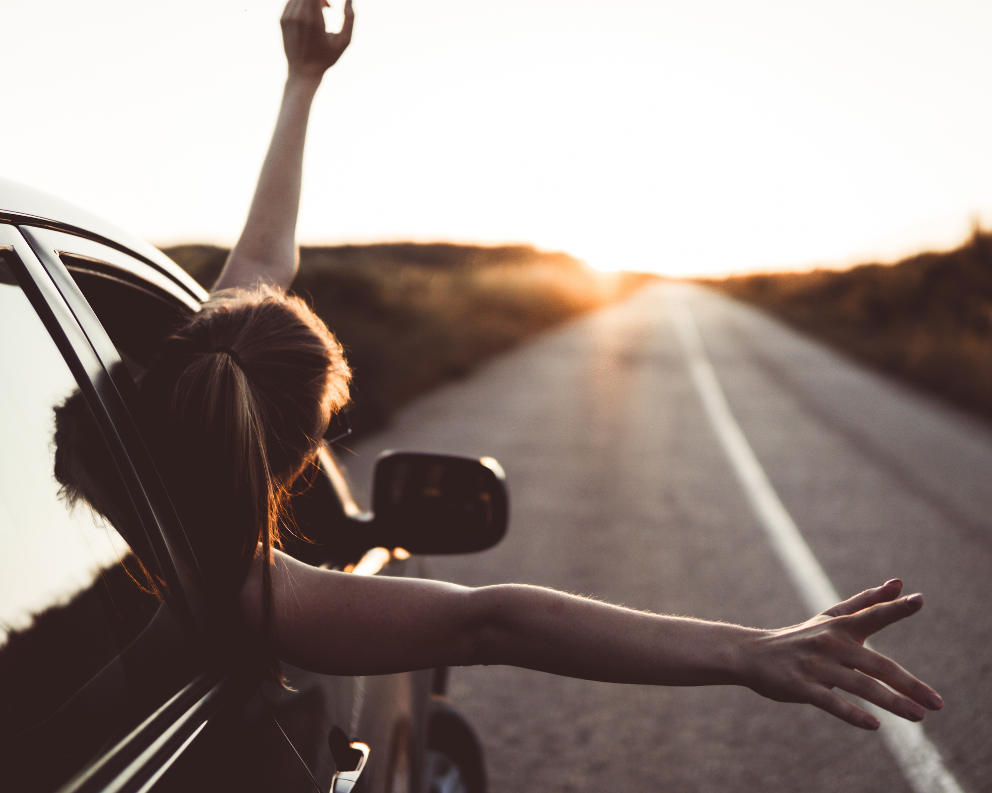Customer Journey improvements Girl in a car enjoying the journey - depicting the importance of continuously improving the client journey in your business