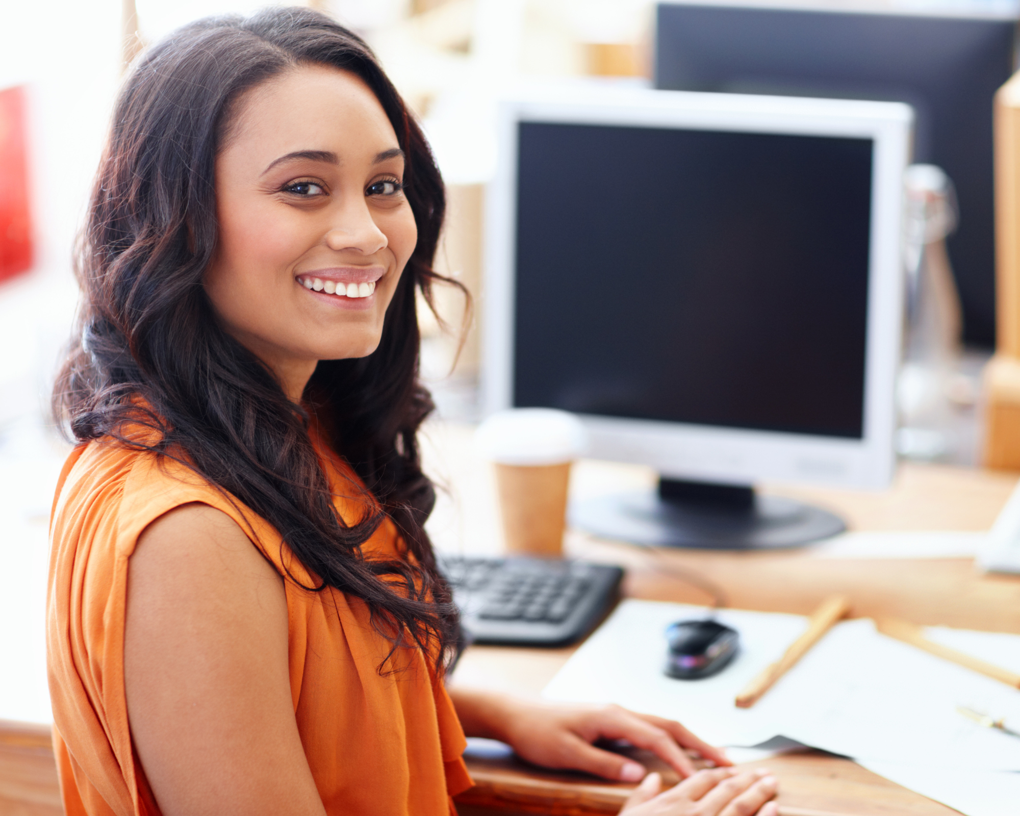 Personalised Experience – happy client Happy person in front of a computer - depicting how personalising the client experience is key