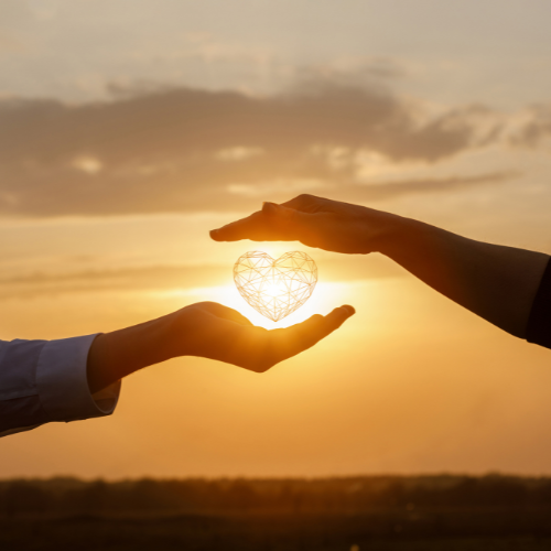 Nurturing long term client relationships Picture of a glowing heart inbetween two hands to depict the importance of nurturing long term relationships with your clients in their business journey